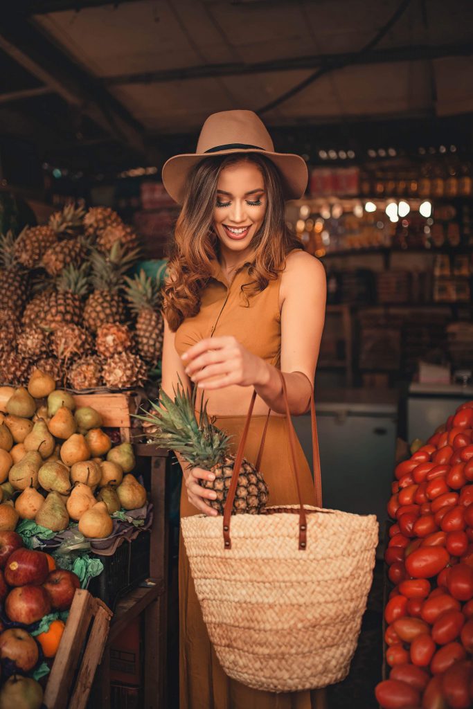 a woman buying pineapples to induce labor