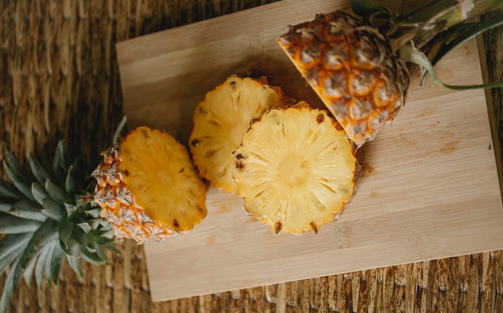 a ripe pineapple on a chopping board