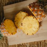 a ripe pineapple on a chopping board