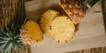 a ripe pineapple on a chopping board