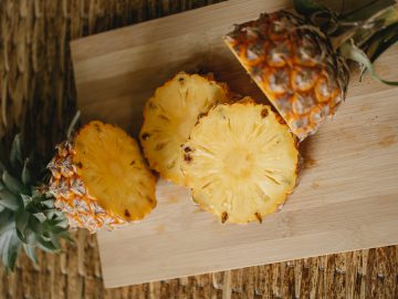 a ripe pineapple on a chopping board